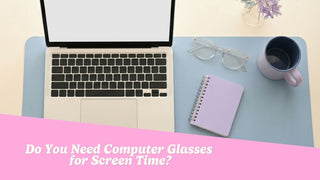 Clear-frame eyeglasses resting beside a laptop on a tidy desk