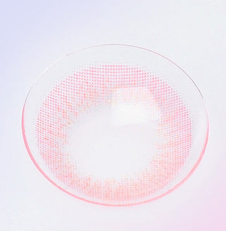 Macro shot of a pink contact lens, showing the radial pattern designed to lighten and brighten eyes, on a light background