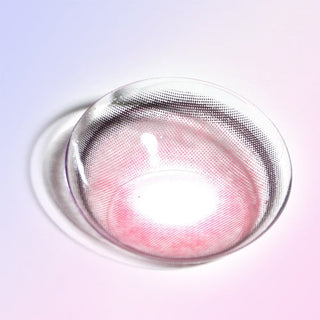Close-up shot of a dark red contact lens, showing a light border and dotted eye-enhancing design, on a light background.