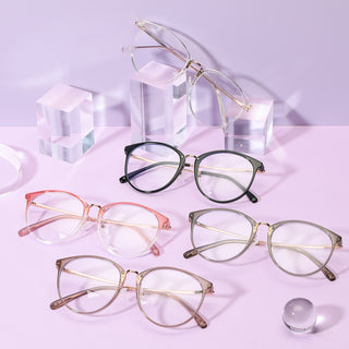 Various colors of the Infinity oversized eyeglass frames, in pink, brown, clear and black, available in blue light blocking lenses and readers, photographed on a purple background, from EyeCandys