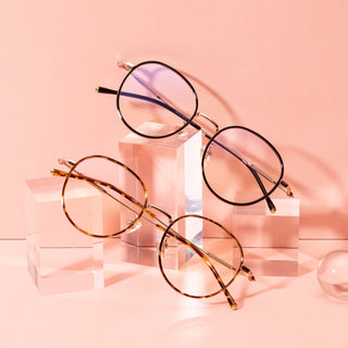 Banger round vintage prescription eyeglasses, available in blue light blocking lenses and in readers with magnification, from EyeCandys, photographed on a pink background