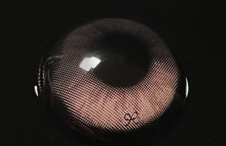 Macro shot of Eyecandys i-Sha Reborn Rosywood prescription colored contact lens, showcasing detailed lens design, natural rosywood tones, and texture.