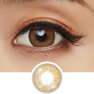 A close-up of a brown eye with long lashes wearing Acuvue Define Fresh Honey (30pk) contacts by Acuvue. Below is a magnified daily disposable lens showing its unique brown and yellow color pattern.
