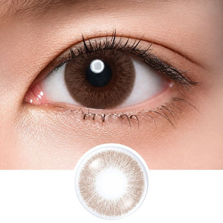 Close-up shot of model's eye adorned with Acuvue Sheer Dream color contact lens dailies, complemented by clean eye makeup, showing the brightening effect of the circle lenses on dark brown eyes, above a cutout of the colour contact lens design with radial spiked pattern