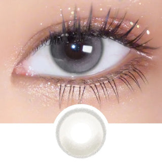 Macro shot of EyeCandys Amelie Earl Grey lens on eye with long lashes, with detailed lens design displayed underneath.