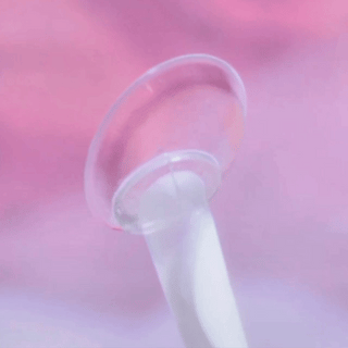 360° of EyeCandys Amelie Sakura Jelly prescription colored contact lens on a contact lens applicator. This soft pink lens enhances the eyes with a natural, dreamy look while providing clear vision and lasting comfort