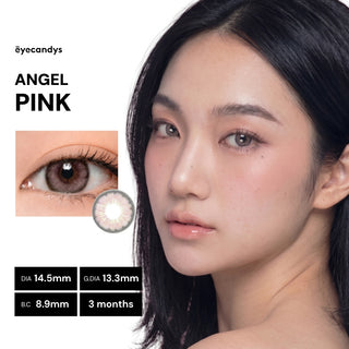 A woman with long black hair wears EyeCandys Pink Label Angel Pink circle lenses for an angelic look. An inset shows a close-up of her eye and lens design, with product details and “Angel Pink” on the left side.