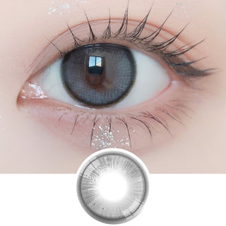 Close-up shot of model's eye adorned with Ann365 Anreen Ash Grey daily color contact lenses with prescription, paired with clean-girl eye makeup, showing the brightening and enlarging effect of the circle contact lens on dark brown eyes, above a cutout of the contact lens with limbal ring on a white background.