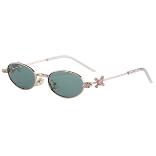 Eyecandys Auden sunglasses in Rose Gold Green featuring elegant green-tinted oval lenses, crystal-studded temples, and a sleek rose gold metal frame – perfect for vintage-inspired style, UV protection, and prescription lens options.