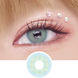 EyeCandys Pink Label Mykonos Blue color contact lens on top of a dark eye paired with peach shimmering eye makeup and curled wispy eyelashes, above the contact lens design.