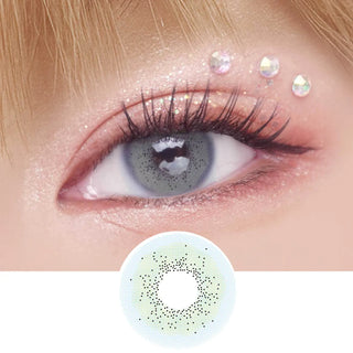 EyeCandys Pink Label Amalfi Blue color contact lens on top of a dark eye paired with peach shimmering eye makeup and curled wispy eyelashes, above the contact lens design.