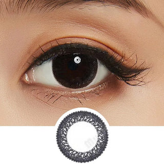 Collage showing Close-up shot of a model eye wearing Lacelle Dazzle Ring Shimmering Black colored contact lens in one eye that is naturally dark-brown with natural eye make up and lashes, Single Lacelle Dazzle Ring Shimmering Black contact lens on a white surface showing the pixel detail