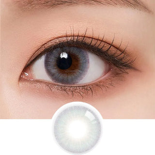 Macro shot of an eye wearing the Olola Blow Midnight Grey (KR) colour contact lens, showing the multi-colored detail and natural effect on dark brown eyes, with clean eye makeup