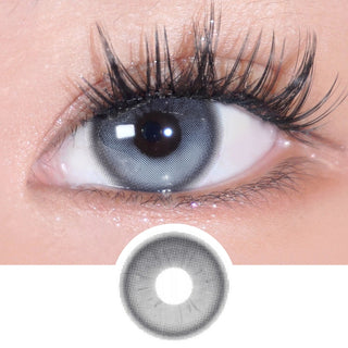 Close-up of naturally dark eye wearing Eyecandys Bunnie Milky Ash prescription colored contact lens with lens design shown below. Long wispy eyelashes, dramatic false lashes, voluminous lash extensions enhance the look