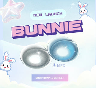 Bunnie colored contact lenses launch promo with pixel art bunnies, pastel background, and two vibrant lens shades in gray and blue. Button reads ‘Shop Bunnie Series’