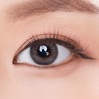 Macro shot of an eye wearing the Olola Dazzling 1-Day Ice Grey (10pk) (KR) prescription colour contact lens, showing the multi-colored detail and natural effect on dark brown eyes.