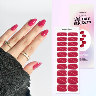 Hand featuring EyeCandys Candy Cane gel nail stickers, with a film displaying the design. Ideal for effortless, trendy nail art with durable, vibrant patterns and a professional finish for at-home manicures
