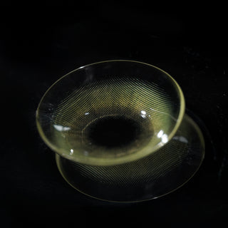 Macro shot of Eyecandys Cashmere Satin Olive prescription colored contact lens, showing detailed lens design and natural olive tones.