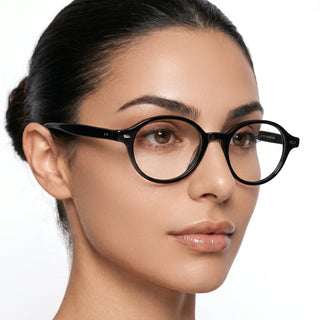 A woman with smooth, clear skin and dark hair pulled back wears EyeCandys Chase Round Oval eyeglasses, looking slightly to the side against a plain white background.