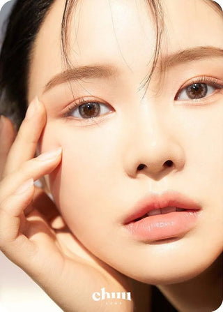 Asian model demonstrating a K-idol-inspired look with Chuu Cloud Pudding Grey (10pk) coloured contact lenses, highlighting the instant brightening and enlarging effect of the circle contact lenses over dark irises.