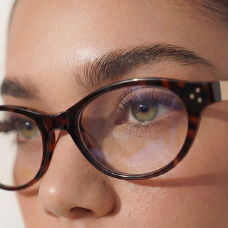 Model wearing EyeCandys Loretta oval unisex glasses, 51mm lens width, 20mm bridge, 145mm temple length, lightweight TR full-frame design