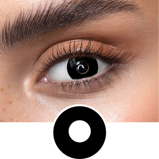 Black eye contact lenses on an dark eye, showing the opacity and vividness of the Halloween contact lens, above a cutout of the black contact lens pattern