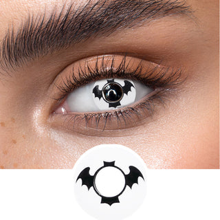 Black and white Batman contact lenses on an dark eye, showing the opacity and vividness of the Halloween contact lens, above a cutout of the contact lens pattern