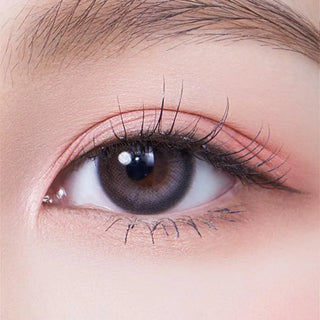 Macro shot of an eye wearing the Olola Daymood Grey (KR) prescription colour contact lens, showing the multi-colored detail and natural effect on dark brown eyes.