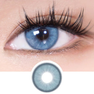 Natural dark brown eye with long lashes wearing EyeCandys Doe Blue lens, showcasing the detailed design of the contact lens.
