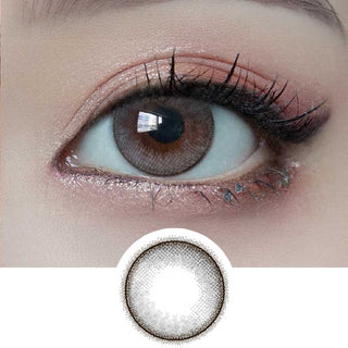 Close-up of eye wearing EyeCandys Dollish Gray colored contact lens with lens design shown below – vibrant gray pattern for a bold eye look. Available as color contact lenses and prescription colored contact lenses