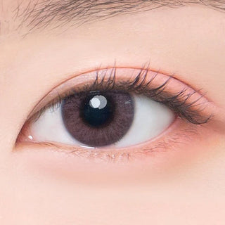 Macro shot of an eye wearing the DooNoon Bono Pink prescription colour contact lens, showing the multi-colored detail and natural effect on dark brown eyes.