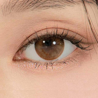 Macro shot of an eye wearing the DooNoon Glam 1-Day Brown (10pk) prescription colour contact lens, showing the multi-colored detail and natural effect on dark brown eyes.