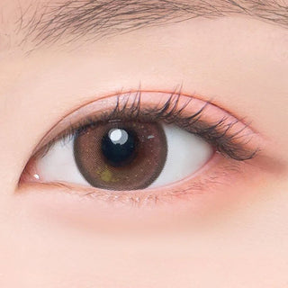 Macro shot of an eye wearing the DooNoon Jinju Beads 1-Day Brown (10pk) prescription colour contact lens, showing the multi-colored detail and natural effect on dark brown eyes.