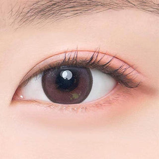 Macro shot of an eye wearing the DooNoon Jinju Beads 1-Day Burgundy (10pk) prescription colour contact lens, showing the multi-colored detail and natural effect on dark brown eyes.