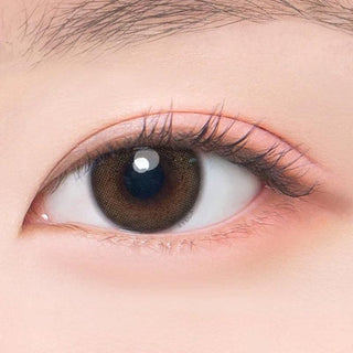 Macro shot of an eye wearing the DooNoon Jinju 1-Day Brown (10pk) prescription colour contact lens, showing the multi-colored detail and natural effect on dark brown eyes.