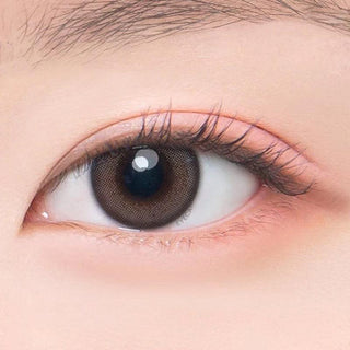 Macro shot of an eye wearing the DooNoon Jinju 1-Day Grey (10pk) prescription colour contact lens, showing the multi-colored detail and natural effect on dark brown eyes.