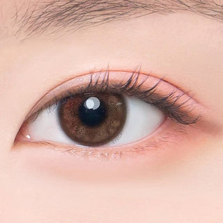 Macro shot of an eye wearing the DooNoon Jinju Shell 1-Day Brown (10pk) prescription colour contact lens, showing the multi-colored detail and natural effect on dark brown eyes.