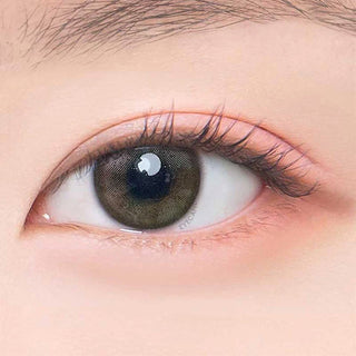 Macro shot of an eye wearing the DooNoon Jinju Shell 1-Day Olive (10pk) prescription colour contact lens, showing the multi-colored detail and natural effect on dark brown eyes.