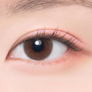 Macro shot of an eye wearing the DooNoon Ppeum 1-Day Brown (10pk) prescription colour contact lens, showing the multi-colored detail and natural effect on dark brown eyes.
