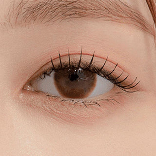 Macro shot of an eye wearing the DooNoon Touch Hazel prescription colour contact lens, showing the multi-colored detail and natural effect on dark brown eyes.