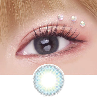 EyeCandys Pink Label Mallorca Blue color contact lens on top of a dark eye paired with peach shimmering eye makeup and curled wispy eyelashes, above the contact lens design.