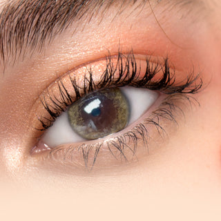 Close-up shot of model's eye adorned with Eyeconic Brown color contact lenses with prescription, complemented by minimalist eye makeup, showing the brightening and enlarging effect of the circle contact lens on dark brown eyes.