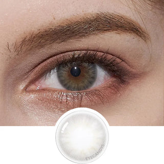 Close-up of model's eye featuring Pink Label Flirty Grey contact lens, complemented by peach eyeshadow, with a cut-out of the same lens below