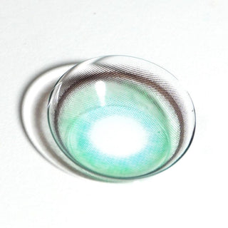 Macro shot of EyeCandys Powerglow Green contact lens — vivid green hue with intense pigmentation, thin limbal ring for iris definition, UV protection, moisture-locking MPC polymer, and antifouling technology for lasting comfort. Ideal for cosplay transformations