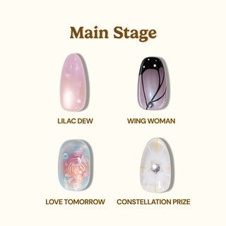 Four decorated EyeCandys Main Stage Press-On Nail Set designs are shown: Lilac Dew (pale lilac shimmer), Wing Woman (black/pink with white dots), Love Tomorrow (pastel swirl with gems), and Constellation Prize (white with silver star).