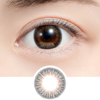 Close-up shot of model's eye adorned with Feliamo 1-Day Tulle Brown (10pk) daily color contact lenses with prescription, paired with clean-girl eye makeup, showing the brightening and enlarging effect of the circle contact lens on dark brown eyes, above a cutout of the contact lens with limbal ring on a white background.