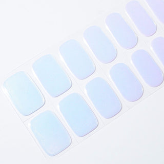 Angled image of semi-cured gel nail stickers in the design 'FIji,' featuring a iridescent cool colors ranging from light blue to pinkish purple, perfect for a stylish manicure.