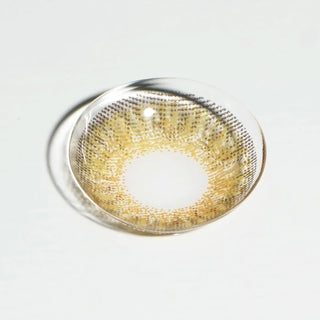 High quality macro shot flatlay of fresh look hazel Contact lens in a plain white backdrop showing the details of the lens