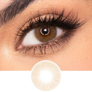 Model with natural dark brown eyes, wispy lashes, and beautiful eyebrows, wearing EyeCandys Glossy Hazel prescription colored contact lens. The lenses feature a natural hazel design that enhances the eye with a soft, warm tone. Perfect for individuals seeking natural looking colored contacts for dark eyes, these prescription colored contact lenses offer comfort and style. The design provides a vibrant yet subtle enhancement, ideal for daily wear and creating a beautiful, natural finish.