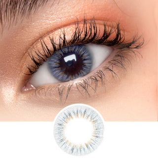 Close-up shot of model's eye adorned with EyeCandys I-Girl Grey daily color contact lenses with prescription, complemented by clean eye makeup, showing the brightening and enlarging effect of the circle contact lens on dark brown eyes, above a cutout of the contact lens pattern with limbal ring on a white background.